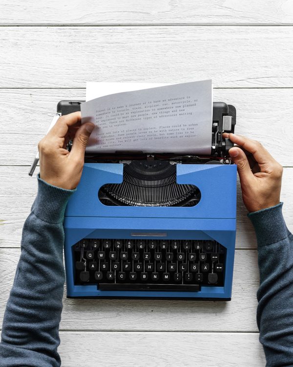 Aerial view of a man typing on a retro typewriter